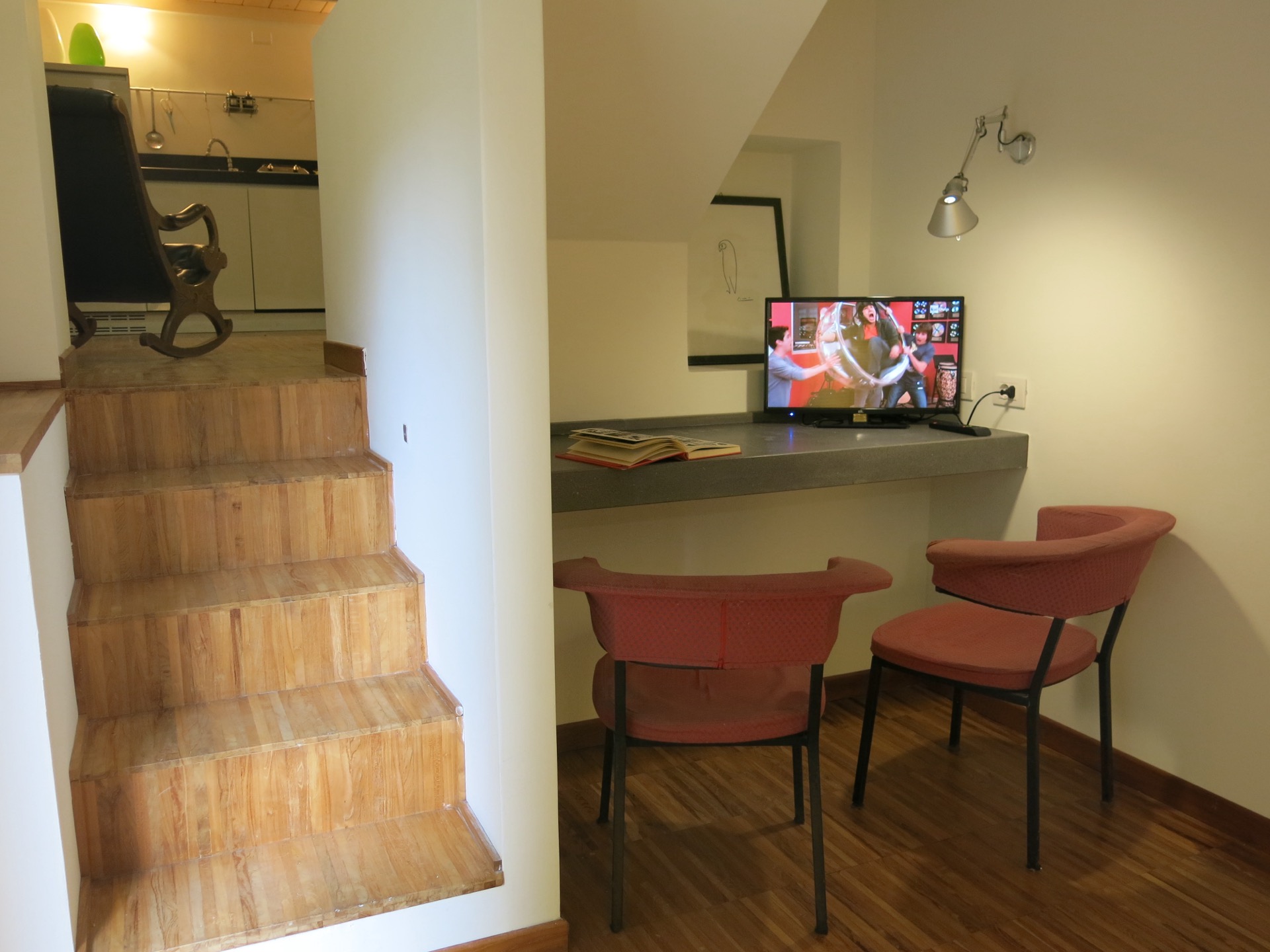 Studio and living room with wooden steps and low seating