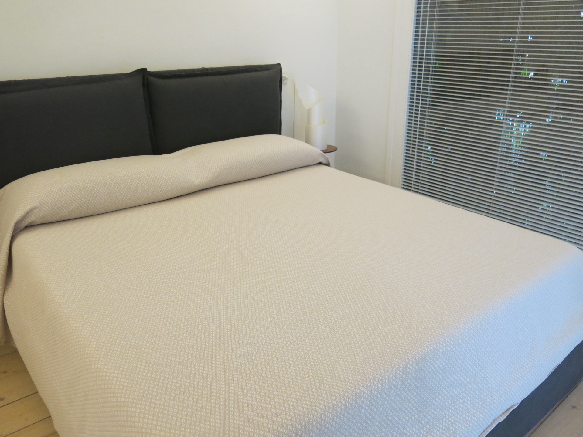 Double bed with wooden headboard