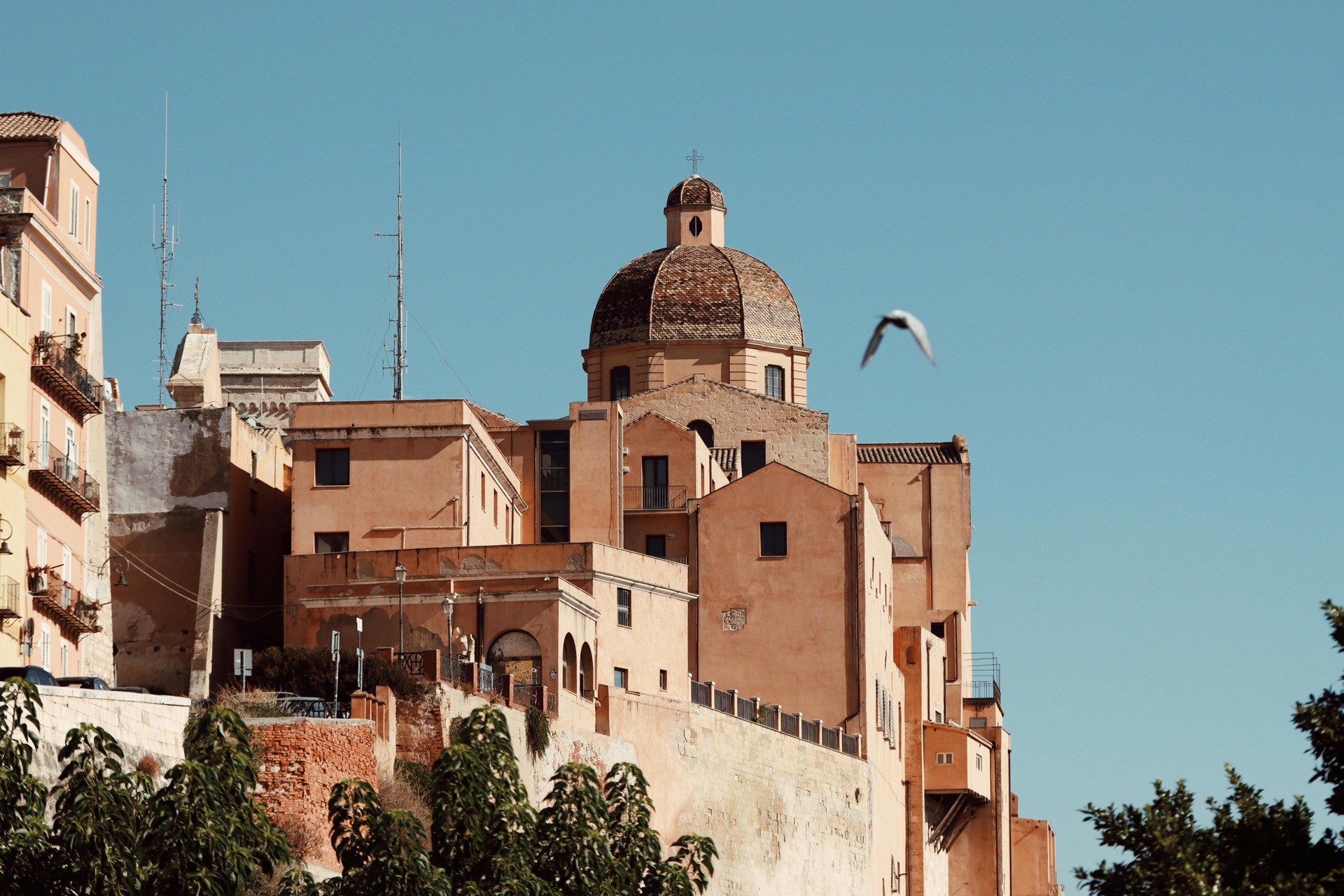 Historic Cagliari cathedral dome under a clear blue sky